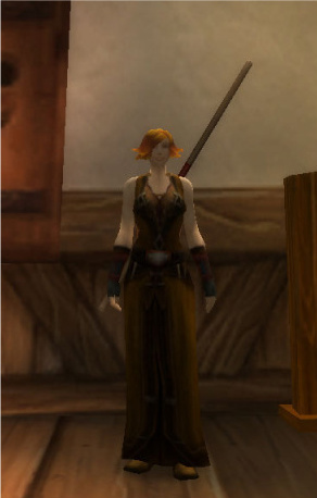 A female human mage with short orange hair in a brown dress.
