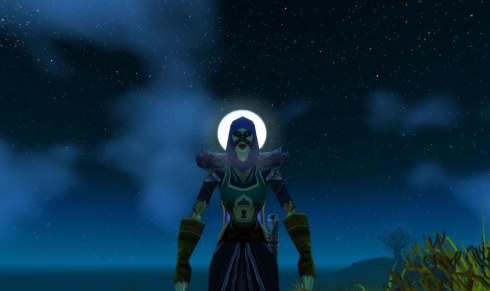 Maiheela stands with the moon directly behind her head.